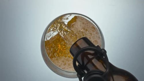 Lager Beer Pouring Glass Closeup. Alcoholic Hoppy Liquid Filling Goblet Slow Motion. Refreshing M...