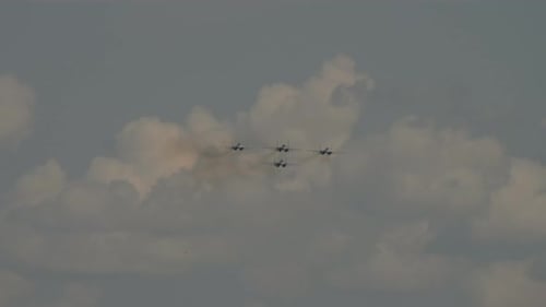 Fighter Jets Flying Through Cloudy Blue Sky
