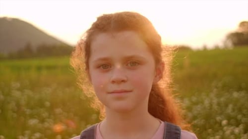 Close up portrait young happy preteen girl kid smiling enjoying summer vacation on beautiful park