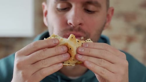 Adult Man Eats Burger Close Up
