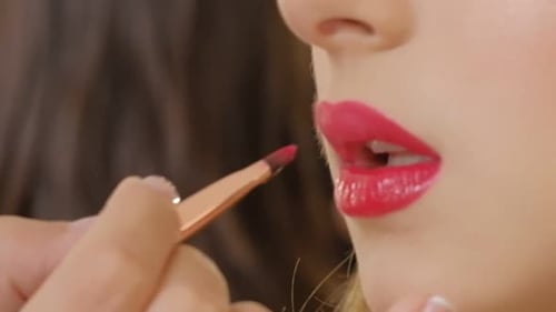Macro Shot of Woman Make Up Mouth Lips Applying Gloss Lipstick with Paint Brush Close Up View Macro