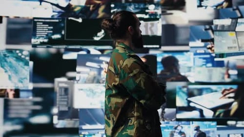 Young Soldier Working in Command Center with Satellite Surveillance