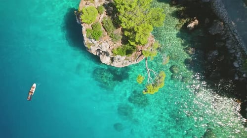 The vibrant blue of the Adriatic Sea surrounds rocky outcrops and sun-kissed beaches in summer Brela