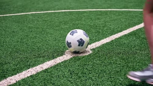 close-up of a soccer player's foot kicking the ball for a penalty or a goal or passing a ball