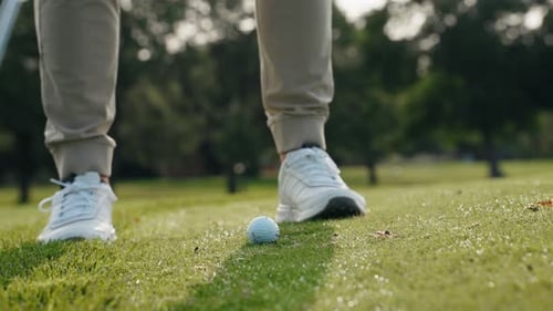 Slow motion of a golf ball being hit from the grass.