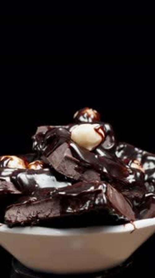 Chocolate and Hazelnuts Rotating in a Bowl