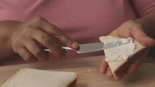 Spreading Creamy Cheese on Toast Close Up
