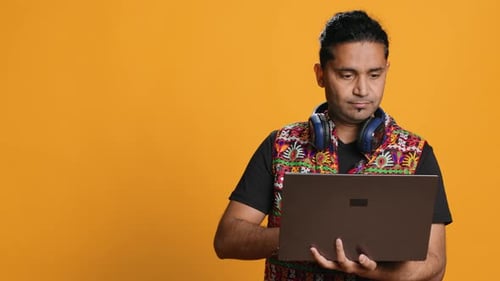 Man Typing on Laptop Frustrated with Malfunctioning Keyboard