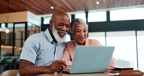 Senior Couple Video Calling on Laptop at Home