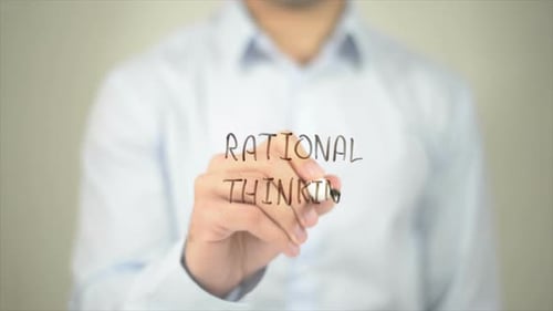 Writing Rational Thinking on Glass Close Up