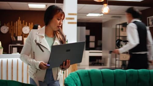 Hotel Guest Finishing Work Tasks on Laptop Upon Her Arrival