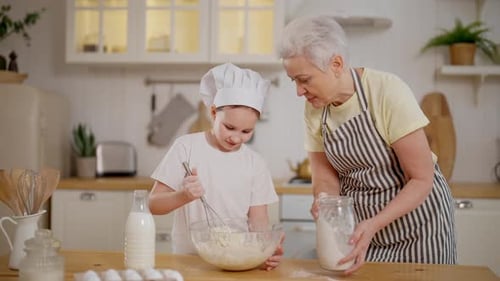 Girl and Woman Baking Together in Sunny Kitchen