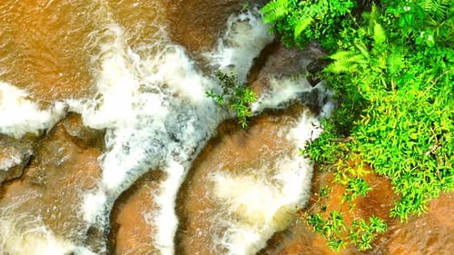 Stunning jungle waterfall, lush greenery - drone view.