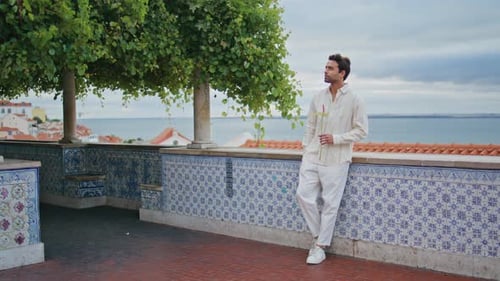 Thoughtful Man Standing on Scenic Urban Overlook