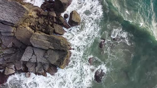 Aerial view Drone camera of seashore rocks. Amazing sea waves crashing on rocks seascape.