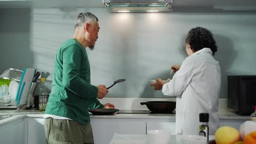 Elderly Couple Cooking Together in a Bright Kitchen