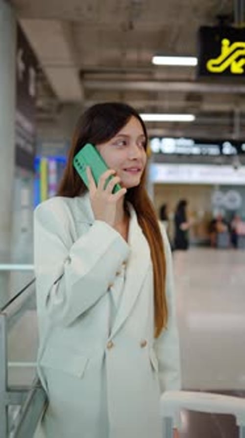 Young woman waiting for departure at the airport on vacation. female passenger using mobile talking