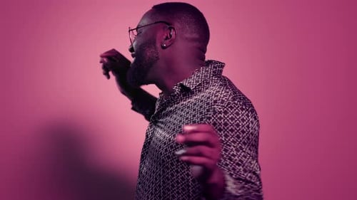 Man Dancing in Front of Pink Background