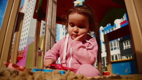 A Young Child Explores Creativity and Play in a Vibrant Sandbox Showcasing Joy and Curiosity While