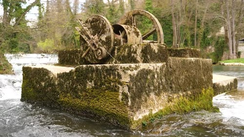 Static shot of the remains of an old mill on a pillar on the Krka River