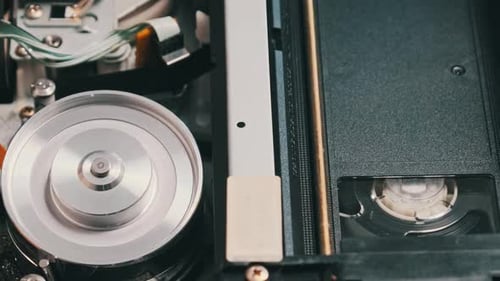 VHS Video Tape Putting Inside a VCR Recorder and Plays