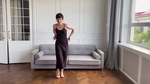 Woman Dancing Gracefully in Room with Natural Light