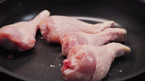 Raw Chicken Drumsticks Placed in Frying Pan