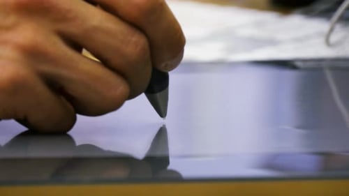 Hand Using Stylus on Tablet for Graphic Design