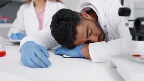 Tired Scientist Resting in a Bright Laboratory