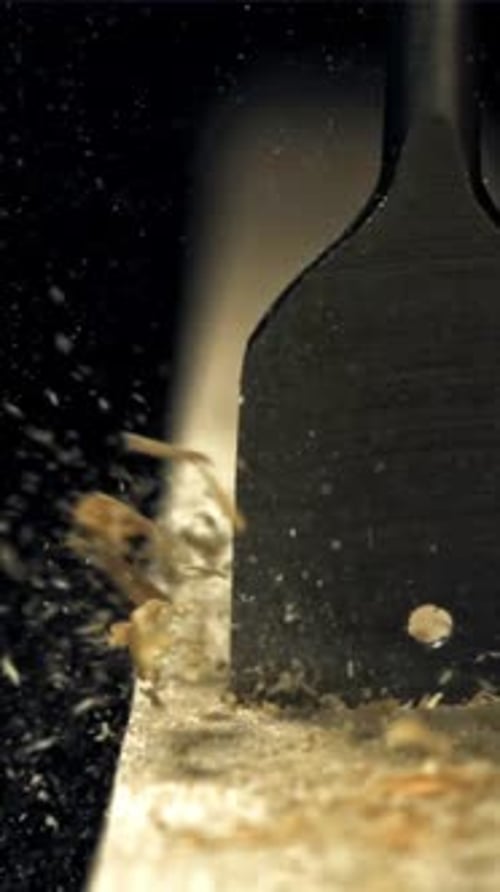 A Carpenter Drills a Hole in a Wooden Product Filmed on a Highspeed Camera at 1000 Fps