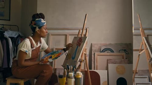 Female Painter Working on New Artwork in Workshop