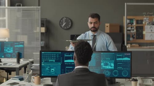 Ethnically Diverse Cybersecurity Officers Coworking in Agency