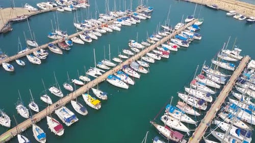 Topdown aerial footage of a marina with small yachts