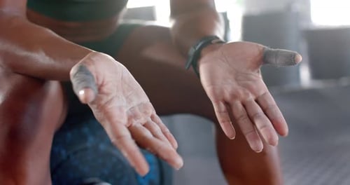 Applying chalk on hands, woman preparing for weightlifting in gym, copy space