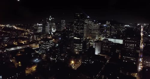 Approaching skyscrapers at night aerial, Montreal