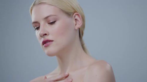 Beautiful Blonde Woman Posing Elegantly in Studio