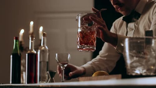 Man Preparing and Pouring Cocktail in Elegant Bar