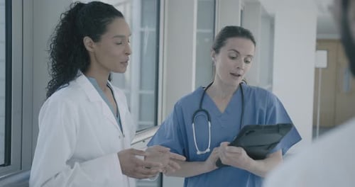 Doctors Discussing Patient Care in a Hospital Hallway