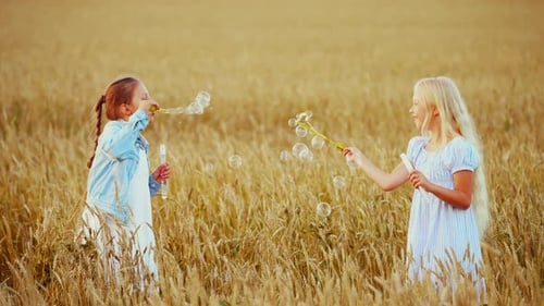 Cute Little Girls Playing with Soap Bubbles