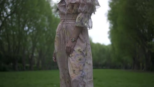 Woman Posing in Floral Dress in Rural Park