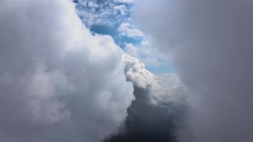 Aerial View From Airplane Window at High Altitude of Earth Covered with Puffy Cumulus Clouds Forming