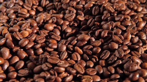 Coffee Beans Background Texture of Coffee Beans Close Up Dark Brown Roasted Coffee is Spinning