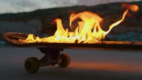 Skateboard Engulfed in Flames at Sunset