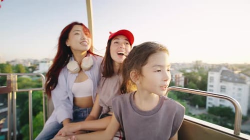 Friends Enjoying Ferris Wheel Ride at Sunset