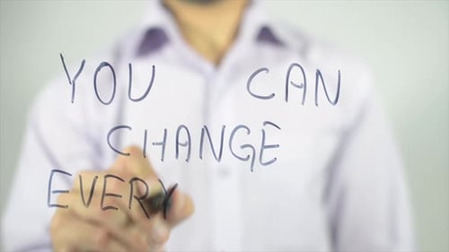 Man Writes Inspiring Message on Transparent Surface