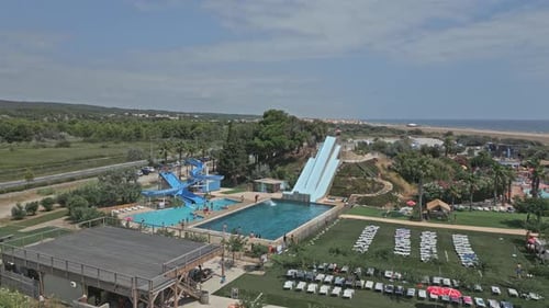 People having fun sliding into waterpark pool