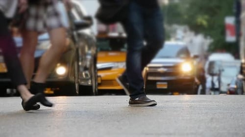 The Urban Street Scene is Vibrant with Pedestrians and Bustling Traffic in the City