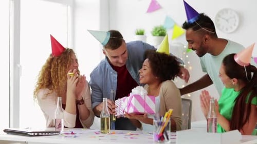 Corporate, Celebration And People Concept - Happy Team With Gifts Greeting Colleague At Office Bi...