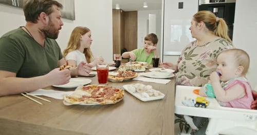 Family Eating Pizza Together at Home