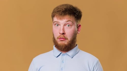A Stunning Studio Shot of a Young Expressive Redhead Guy with a Shocked Expression